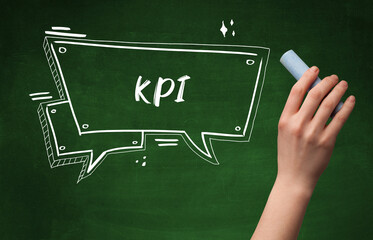 Hand drawing KPI abbreviation with white chalk on blackboard