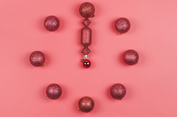 Clock from New Year's toys on a red background. The time is 00.00. Christmas card