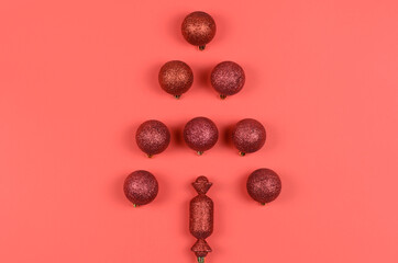 Christmas tree made of New Year's toys on a red background. Christmas card