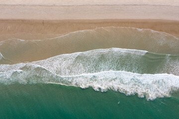 The Atlantic Ocean washes onto a scenic, sandy beach on Cape Cod, Massachusetts. This scenic peninsula is a popular summer vacation destination in New England.