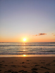 Naklejka na ściany i meble golden sunset sky on the beach