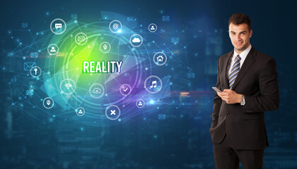 Businessman thinking in front of technology related icons and REALITY inscription, modern technology concept