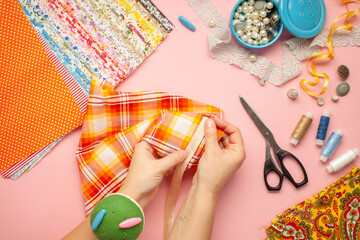 Fototapeta premium Materials and accessories for sewing - fabric, pins, thread, buttons. Top view. Flat lay