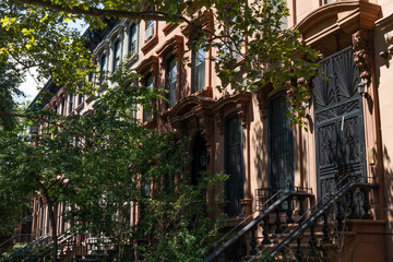 Fototapeta premium Row of Old Brownstone Homes in Clinton Hill in Brooklyn of New York City with Staircases
