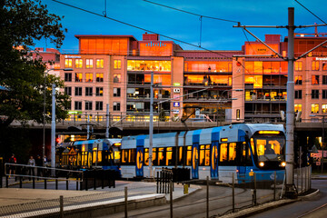 Blue tram on street of Stockholm at sunset, Sweden