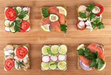 Set of sandwiches on a wooden background.
