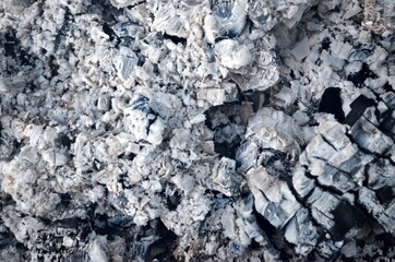 Coals in an extinct fire. Natural gray background. Coal and ash in a burnt fire