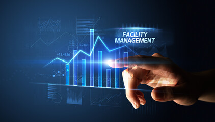 Naklejka premium Hand touching FACILITY MANAGEMENT button, business concept