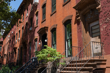 Fototapeta na wymiar Row of Old Brownstone Homes in Clinton Hill in Brooklyn of New York City with Staircases