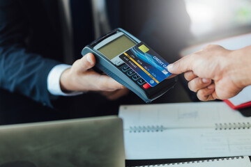 Customer holding credit card and putting it to the card payment machine