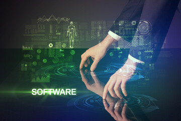Businessman touching huge display with SOFTWARE inscription, modern technology concept