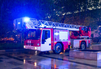 Fire engines in the courtyard of the apartment building where the fire occurred, at night during...