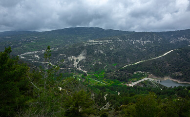 Forest-covered green hills on a bright Sunny summer day in the mountains of Central Cyprus.