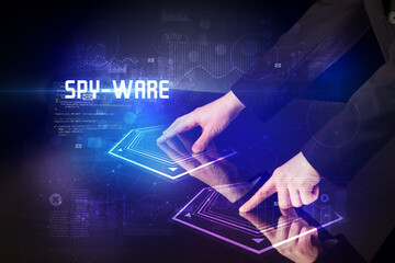 Hand touching digital table with SPY-WARE inscription, new age security concept