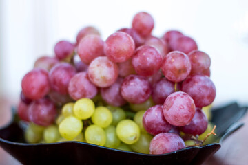 Red and White wine bunch of grapes in the black plate
