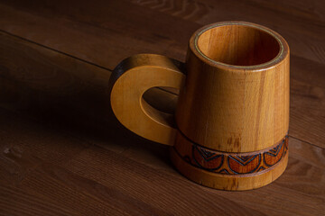 Wooden mug on a wooden table. Wooden dishes. Antique dishes.