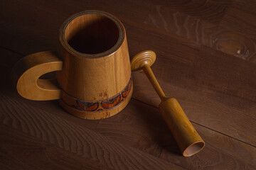 Wooden mug on a wooden table. Wooden dishes. Antique dishes.