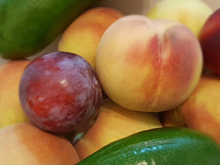still life of peaches plums and avocado environmentally friendly
