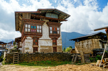 Bhutan, traditional farm house in the countryside with beautiful wooden decoration