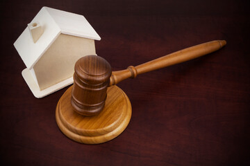 Real estate business and auction concept, judge gavel and house  on wooden table