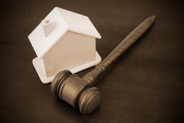 Real estate business and auction concept, judge gavel and house  on wooden table