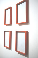 four picture frames hung on a white wall