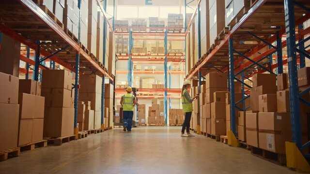 Retail Warehouse full of High Shelves with Goods in Cardboard Boxes has Team of Professionals Scan and Sort Packages, Operate Hand Pallet Trucks and Forklifts. e-Commerce Products Distribution Center 