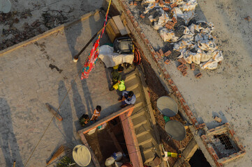 Village people with animals decided to live in polluted city with garbage, trash and sever line.