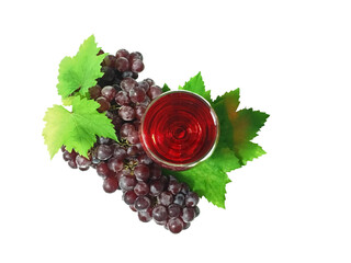Top view of red wine glass and ripe seedless grapes isolated on white background. Celebration beverage.