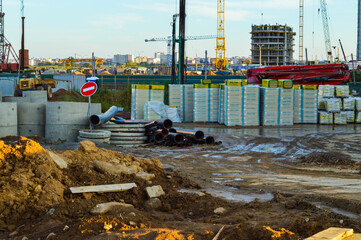 construction site in the city center. tumbled down the stop sign.  building materials are piled in...