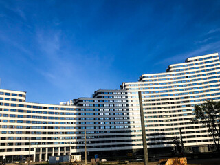 residential building of different heights in the form of a wave. non-standard execution, house in the Arabian style. many transparent and clean windows. residential building without balconies