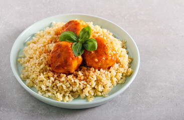 Chicken meatballs over bulgur wheat