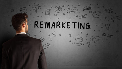 businessman drawing a creative idea sketch with REMARKETING inscription, business strategy concept