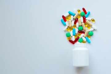White bottle with different pills, drugs on white background, flat lay.
Space for text. Top view. - 378970943