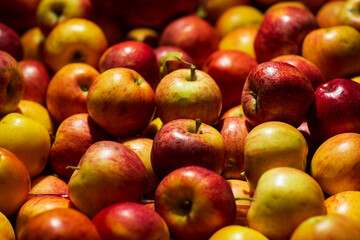 Background of apples fruits. Selective focus. Fresh Juicy apples Heap on Market Stall red apples in the market. Blurred background.