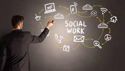 businessman drawing social media icons with SOCIAL WORK inscription, new media concept
