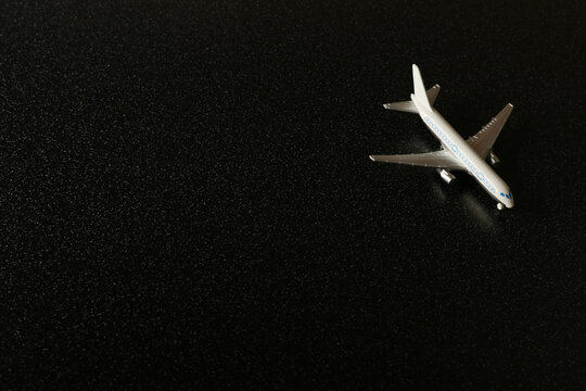 tourism concept with copy space. toy airplane on dark black background