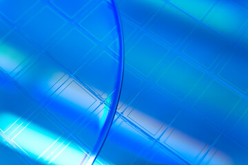 Macro of blue silicon wafer with microchips.