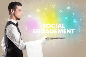 Waiter serving social networking with SOCIAL ENGAGEMENT inscription, new media concept