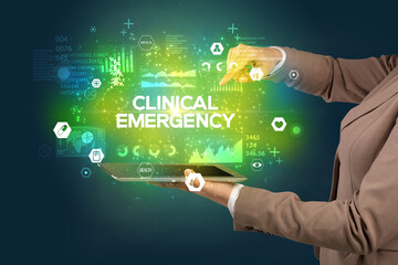 Close-up of a touchscreen with CLINICAL EMERGENCY inscription, medical concept