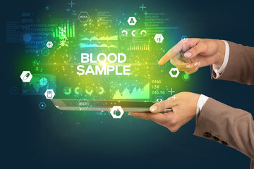 Close-up of a touchscreen with BLOOD SAMPLE inscription, medical concept