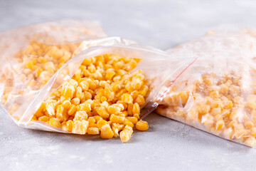 Open bag of uncooked frozen corn