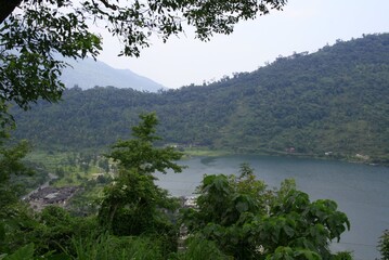 Beautiful view of the mountain with green trees and the water lack