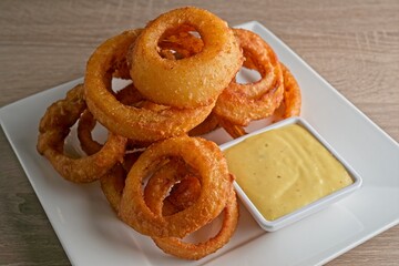 Crispy, beer battered onion rings, with Sriracha ranch & honey mustard.