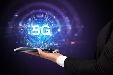 Close-up of a touchscreen with 5G abbreviation, modern technology concept