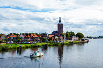 Landscape with church and river at Hasselt, Netherlands
