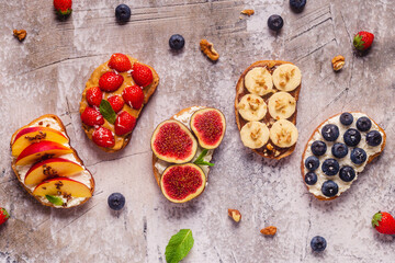 Homemade summer toast with cream cheese, nut butter and fruits and berries