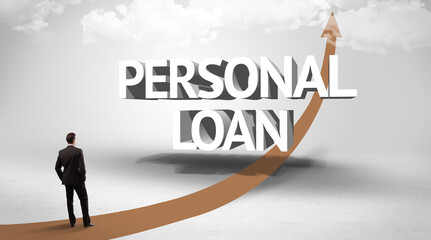 Fototapeta premium Rear view of a businessman standing in front of PERSONAL LOAN inscription, successful business concept