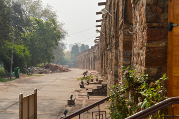 A mesmerizing view of architecture of small tomb at old fort from side lawn with trees.