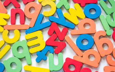 Multi colored English alphabet made from wood isolated on white background.